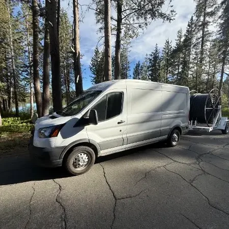 Mountain Plumbing Solutions service van at a snow-covered Sierra Nevada mountain home in the Truckee area